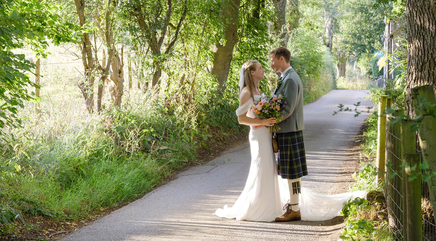 Summer wedding at Losehill House in The Peak District. A portrait of the wedding couple in the evening summer sunshine, after their outdoor wedding in Derbyshire.